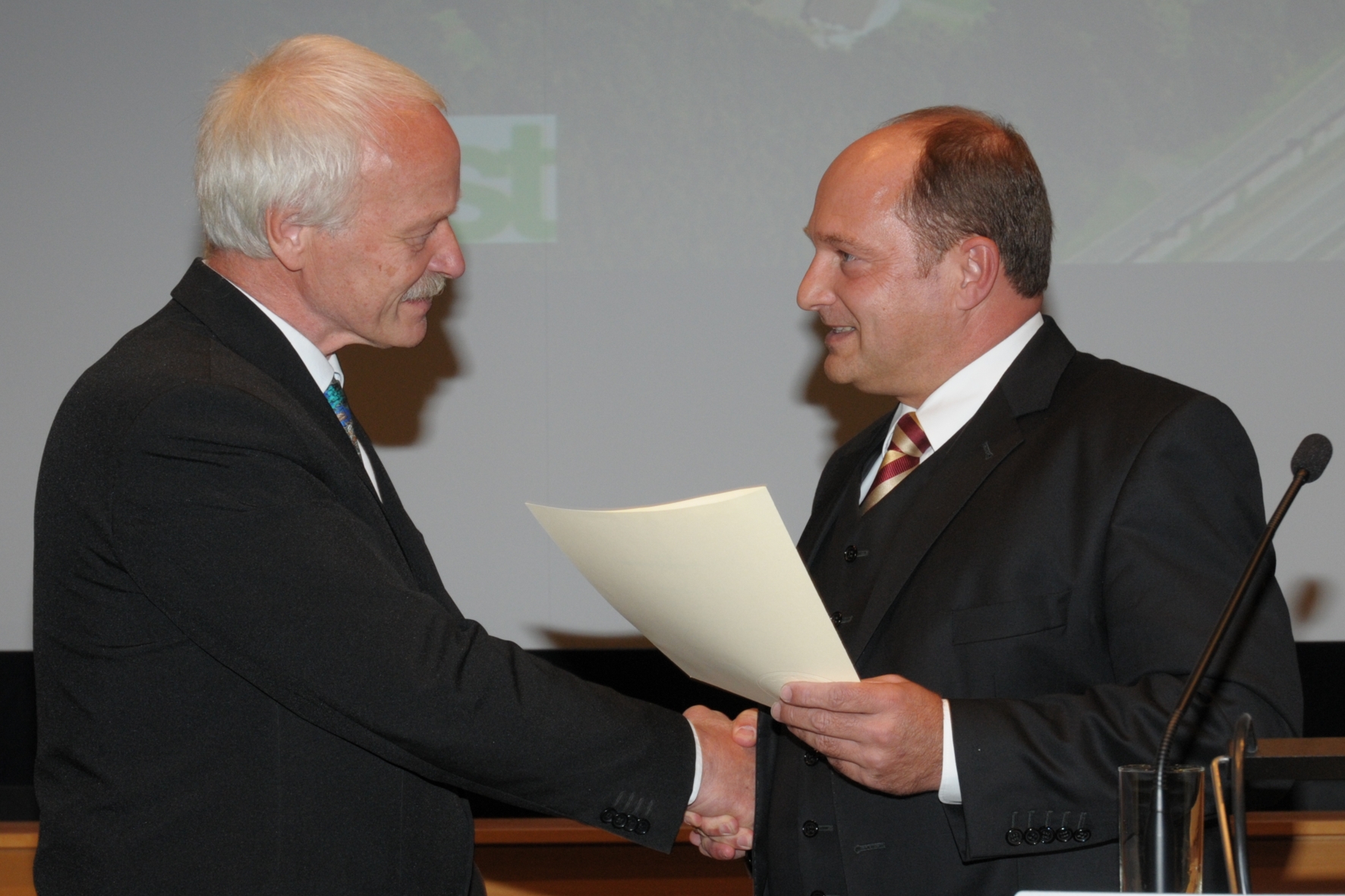 Dr. Peter Reichelt gets the official document of his retirement from State Secretary Rainer Bomba